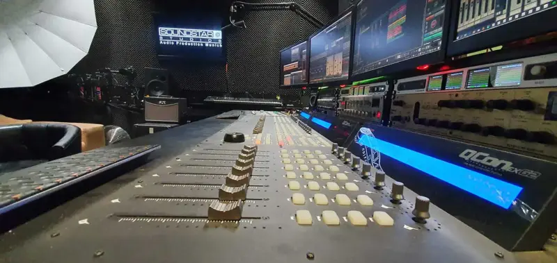 Audio postproduction 3 Professional mixing console in the control room of SOUNDSTARSTUDIOS Recording Studio Munich with multi-monitor DAW setup and outboard gear